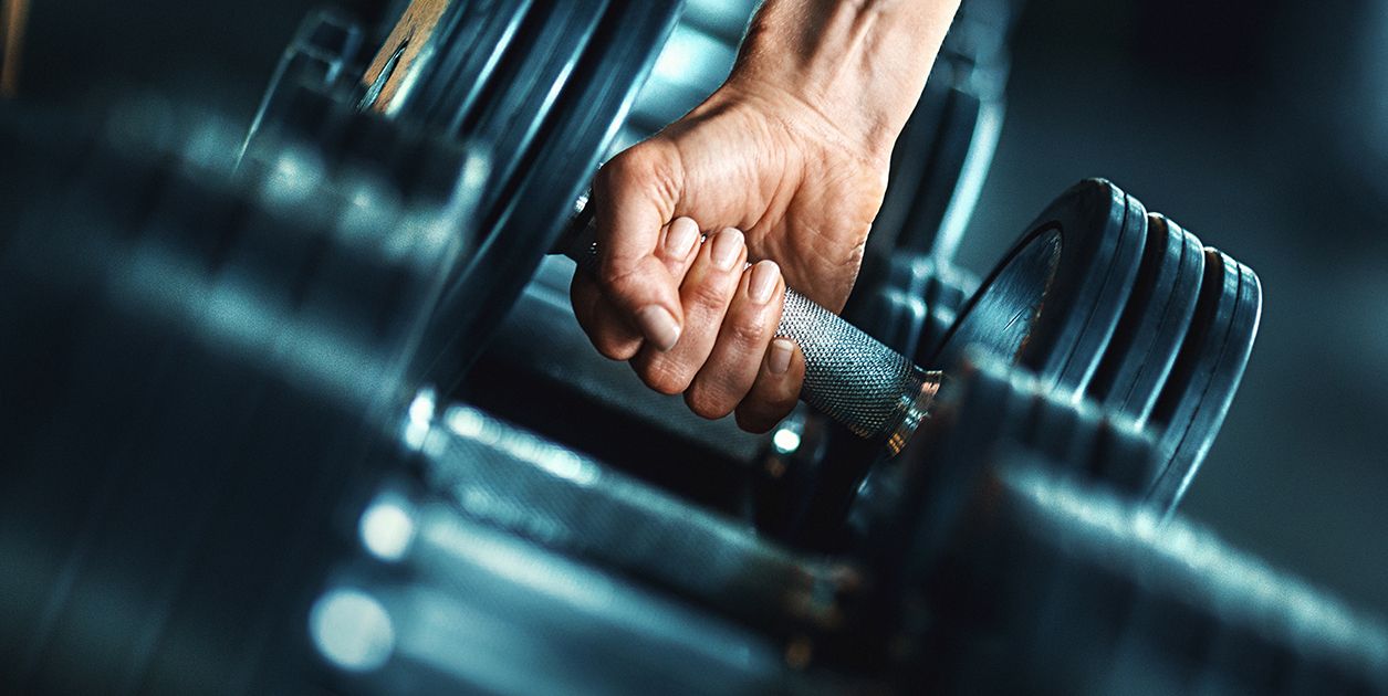 Close up of a hand holding a dumbbell