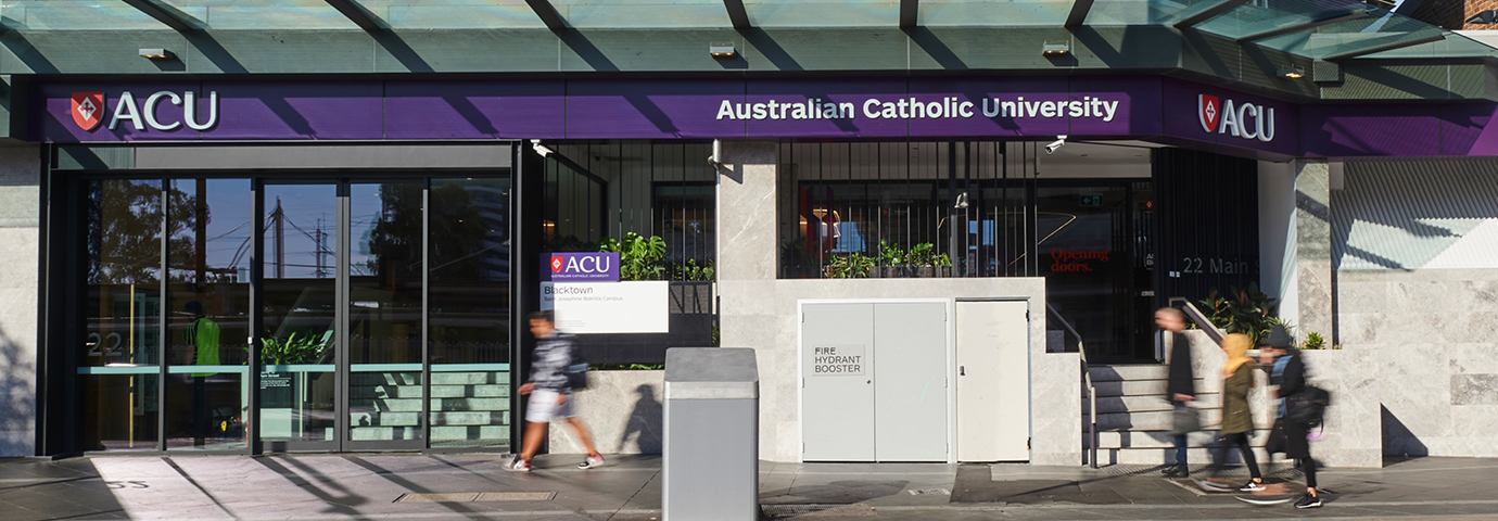 Street view of the entrance to the Blacktown Campus with students walking in front