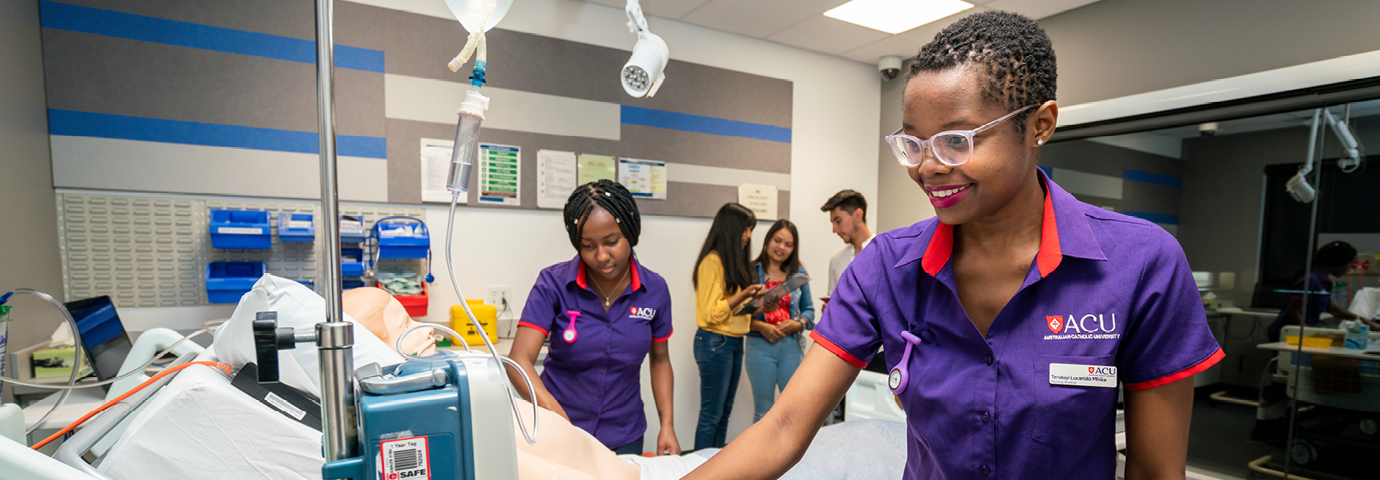Nursing student interacts with medical equipment in a simulation ward