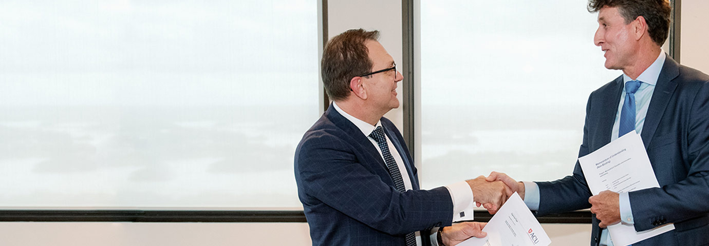 ACU VC and President Professor Zlatko Skrbis shakes hands with Microsoft ANZ Managing Director Steven Worrall after signing an MOU.