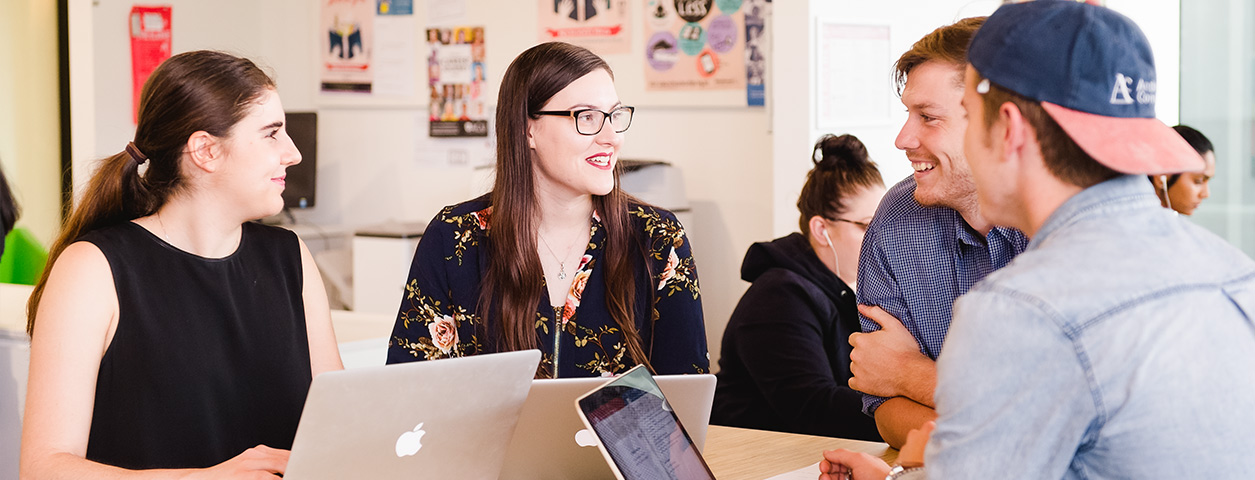 A group of students sit around talking