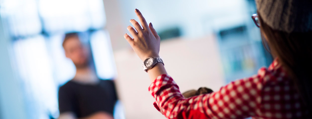 Person's arm being raised in an attempt to ask a question.