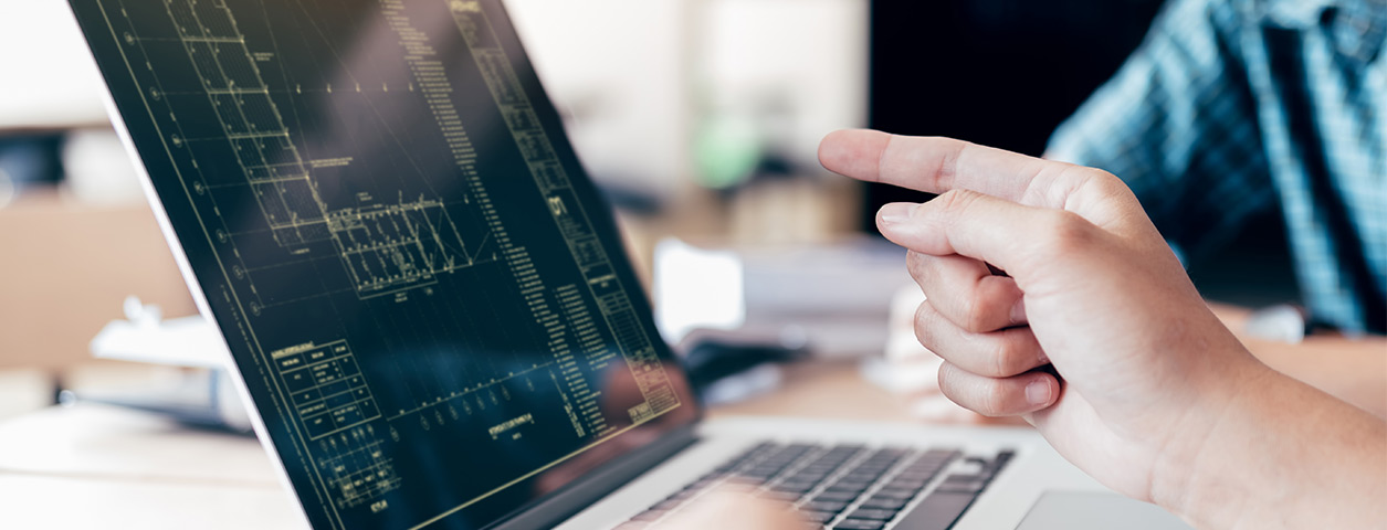 A finger pointing at a laptop computer rendering complex digital graphs.