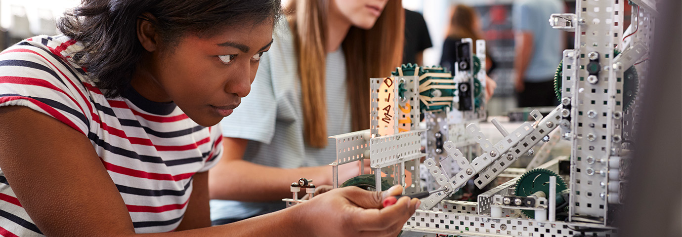 A student is involved in STEM learning, building a mechanised object