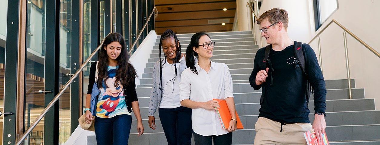 Student walking down stairway.
