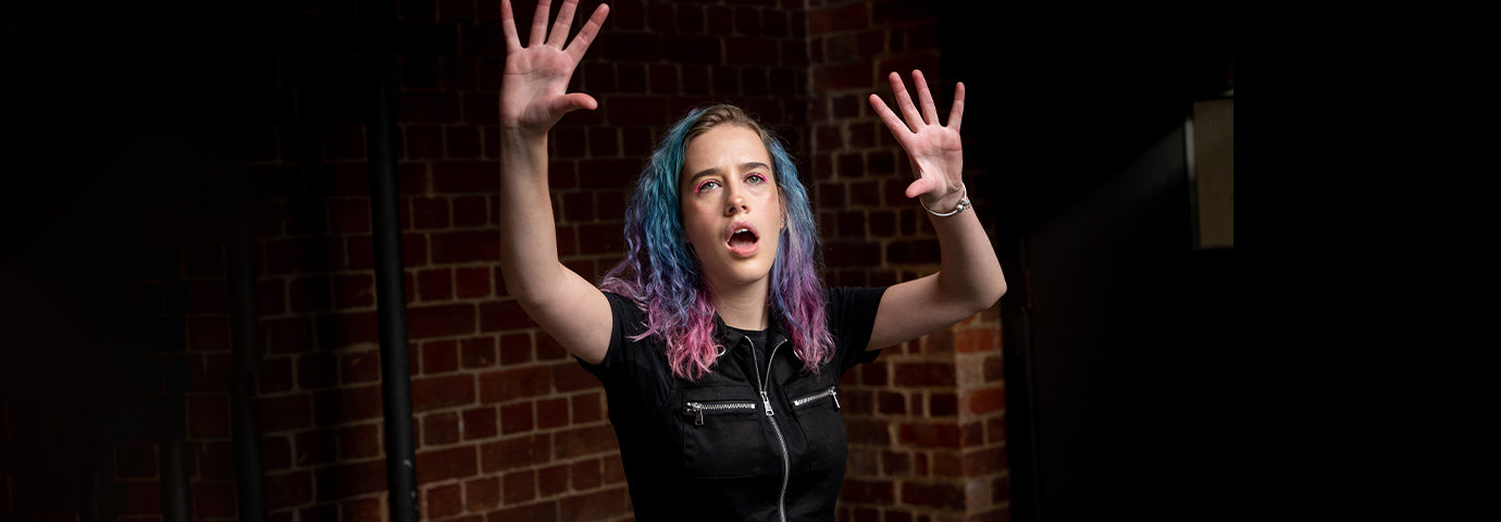 An ACU drama student is performing.