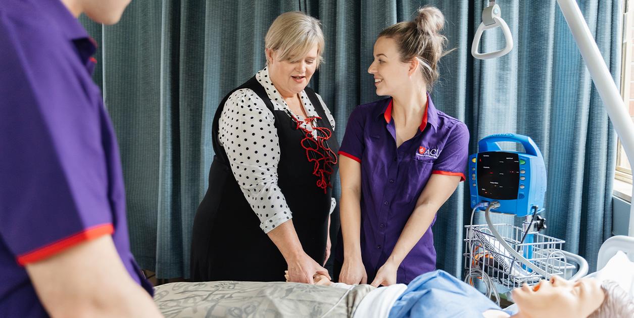 An ACU student and instructor simulate a healthcare procedure