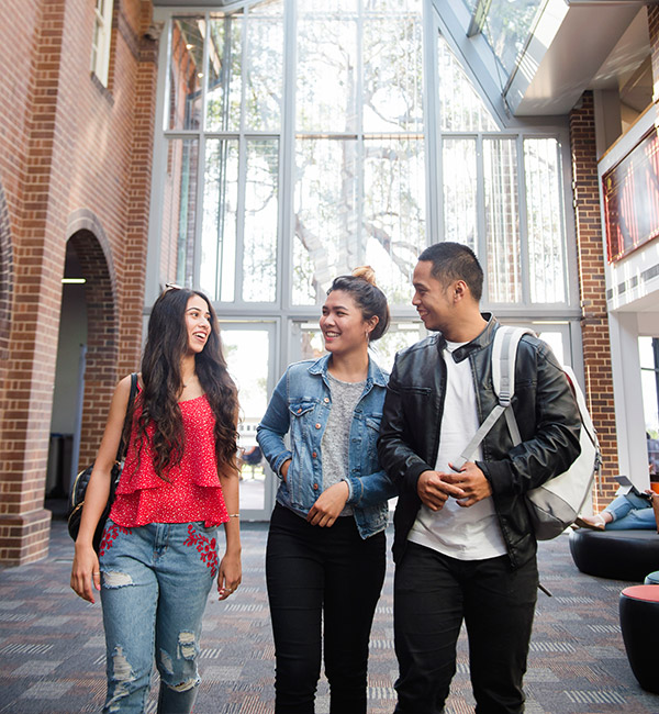 Three studies walk abreast, talking
