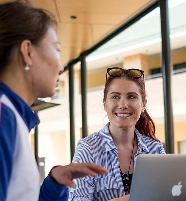 ACU ancient languages students working together on a laptop