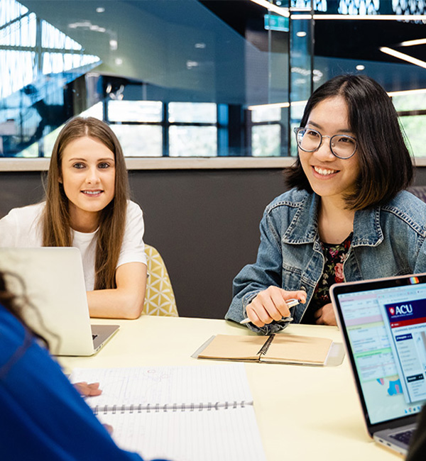 ACU business studies students working on their laptops