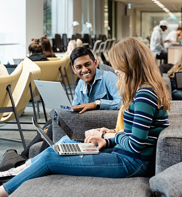 ACU geography students working on their laptops in the library