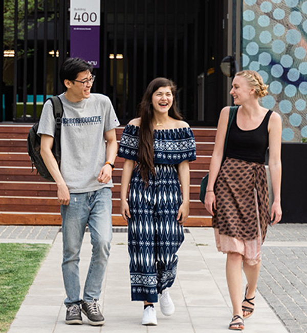 ACU graphic design students walking through campus