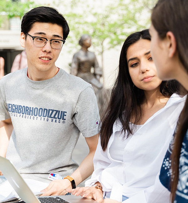 ACU international development studies students discussing their work