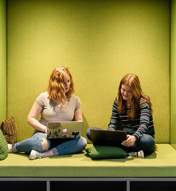 ACU logic students in the library discussing their work