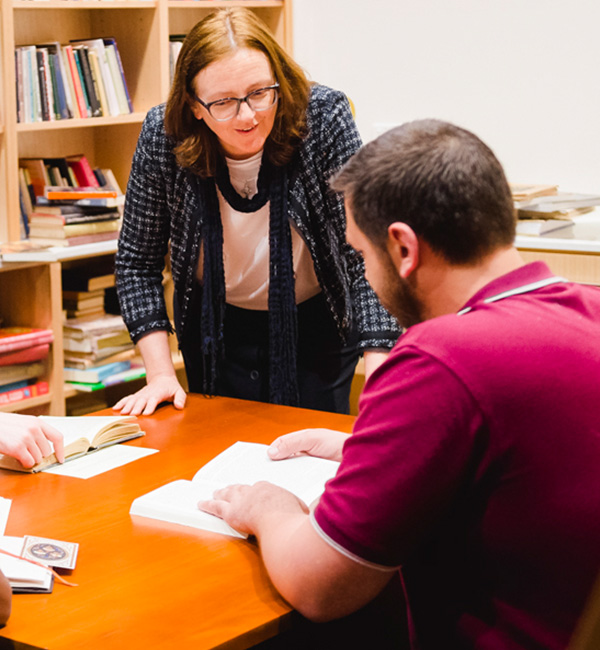 ACU Practical theology and ministry student in discussion with a staff member