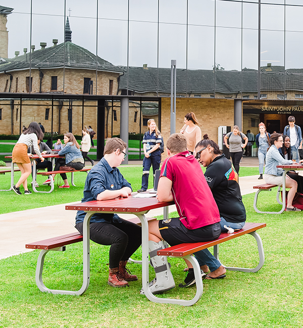 ACU Secondary education students sitting at an outdoor table on campus