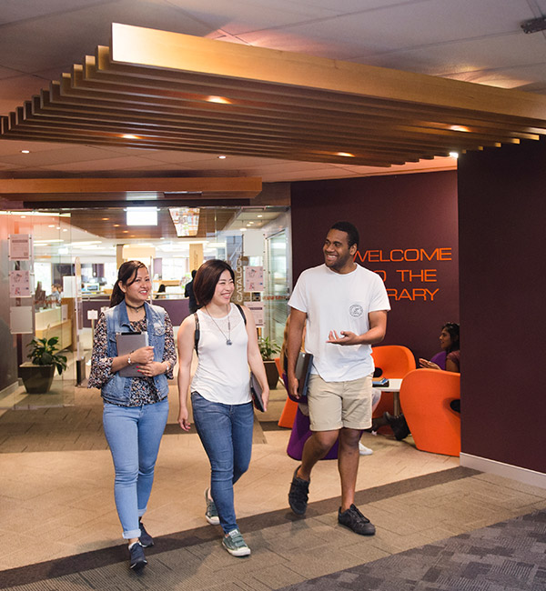Three students are walking and talking