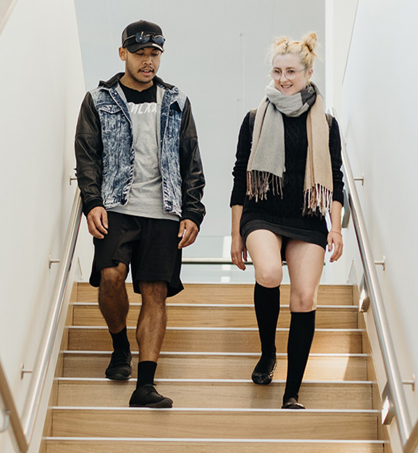 ACU youth work students walking down stairs on campus