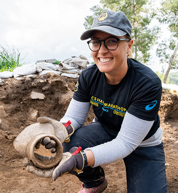  ACU archaeology student, Michaela, showing off a discovery at the Lachish digsite in Israel.