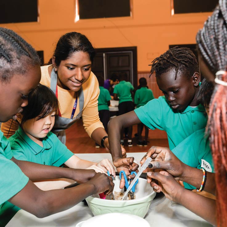 ACU staff member facilitating an interactive class activity with children.
