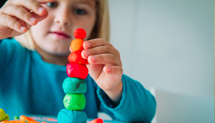  preschool child building tower of blocks
