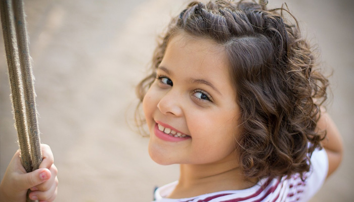 similing young girl on swing