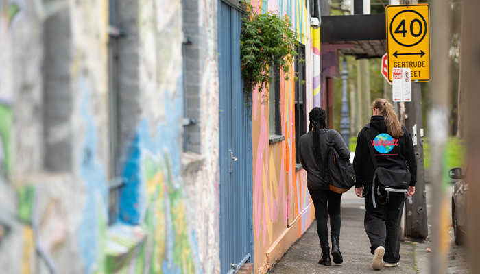 ACU students walk down an urban street