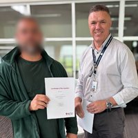 photo of people holding up a certificate