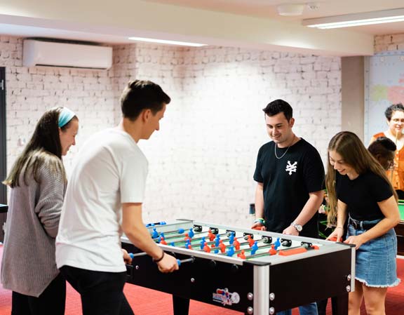 Students playing table soccer.