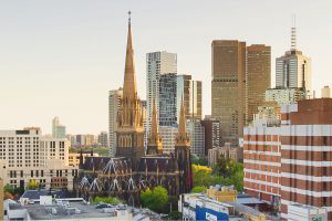 An aerial photo of the Melbourne cityscape. StPatrick's Cathedral is prominently featured.